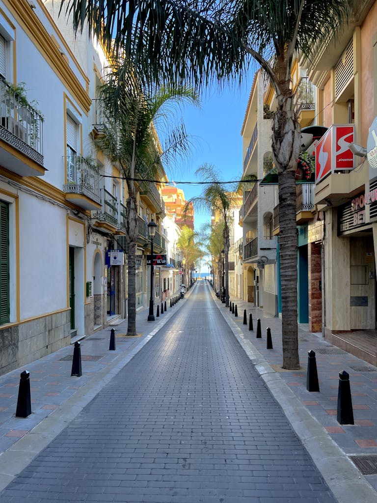 Explore the tranquil, narrow streets of Fuengirola lined with palm trees and vibrant architecture.